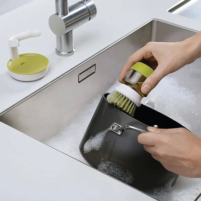 Brush with dispenser for dishes